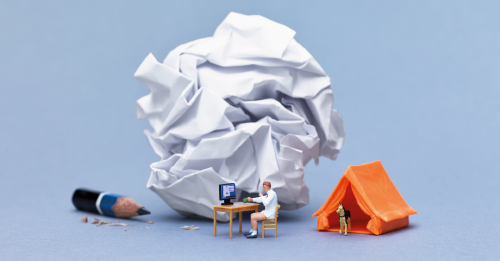 amasol miniature world with a home-office desk, and a crunched up paper wiith a tent and a sharpened pencil