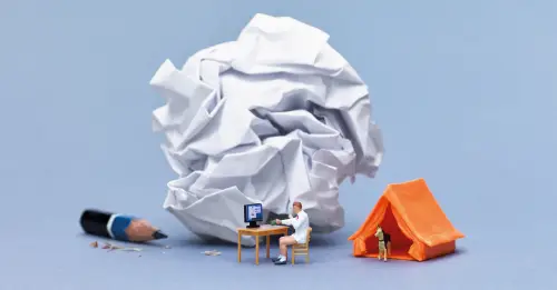 amasol miniature world with a home-office desk, and a crunched up paper wiith a tent and a sharpened pencil