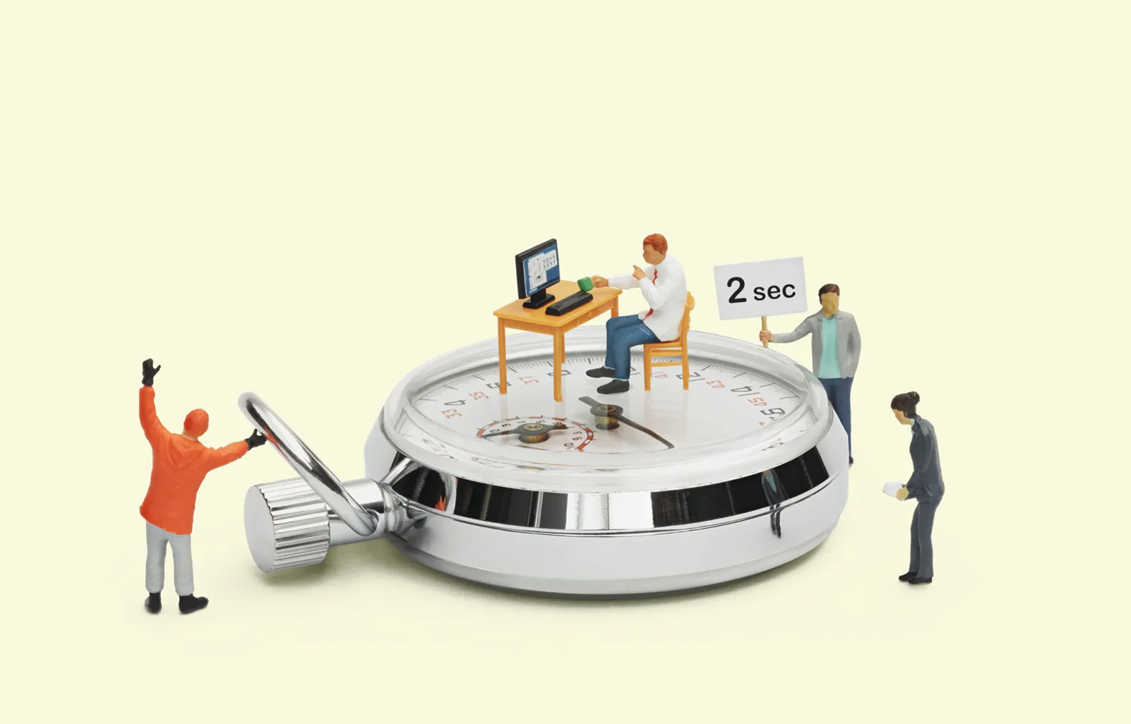 Stopwatch with miniature people representing IT performance, response times and system monitoring.